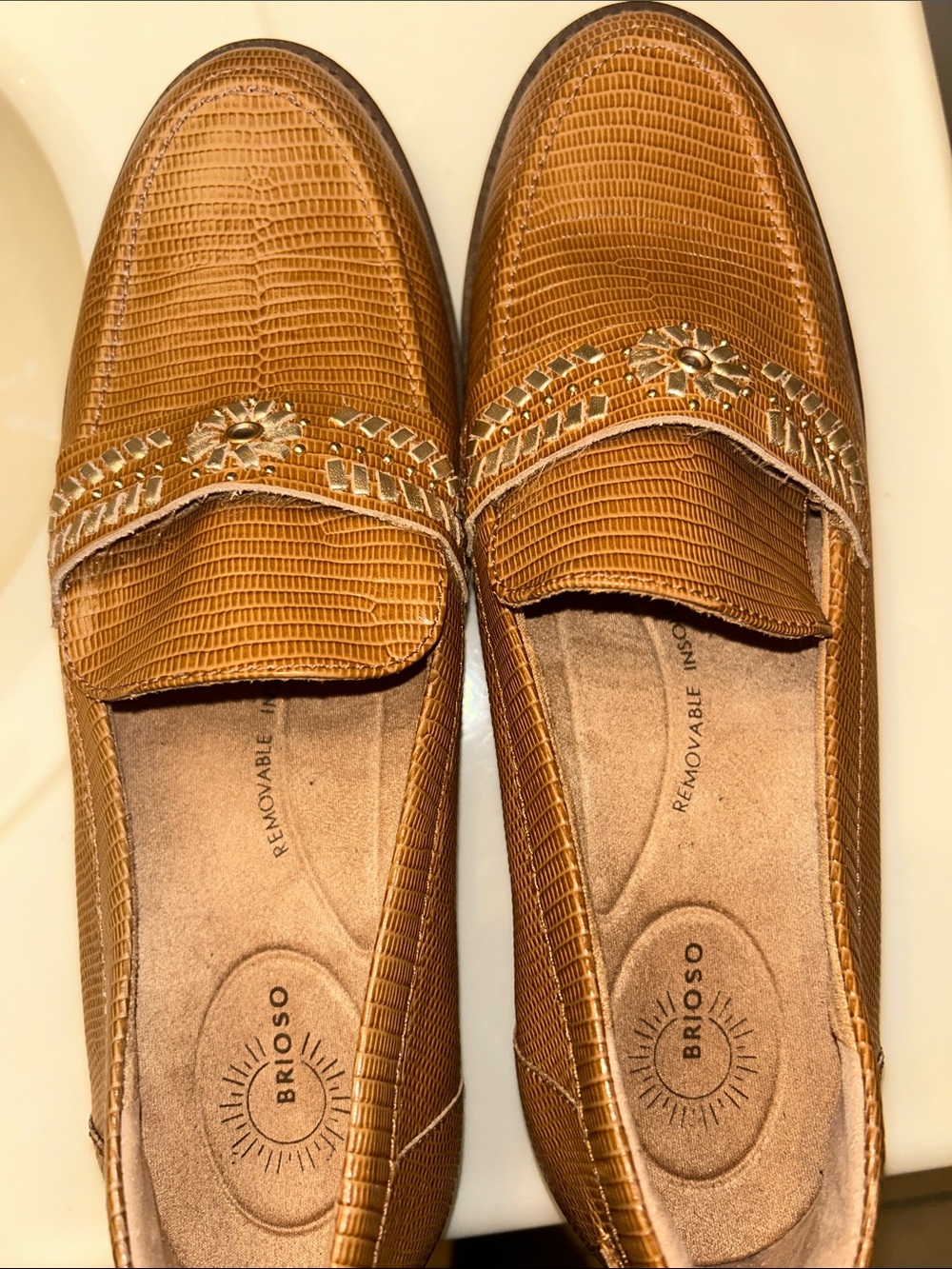 Brioso Tan Textured Loafers with Decorative Emblem